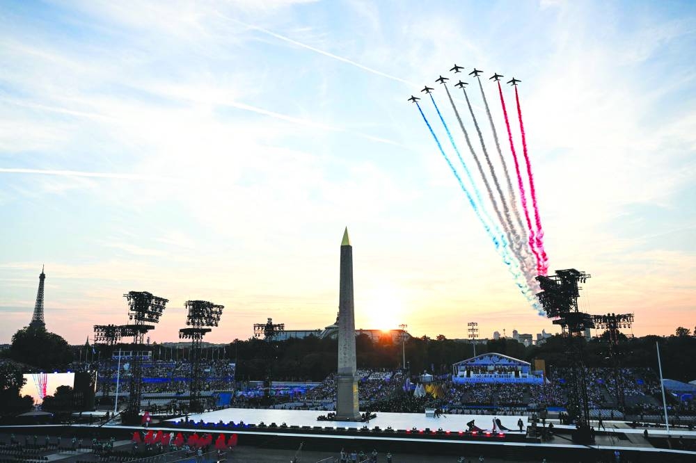 
French Air Force Elite acrobatic flying team “Patrouille de France” perform over the Place de la Concorde during the Paris Paralympic Games Opening Ceremony. (AFP) 