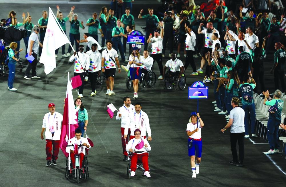 Ali Radi Arshid of Qatar and Sara Hamdi Masoud of Qatar lead their contingent during the opening ceremony. (Reuters)