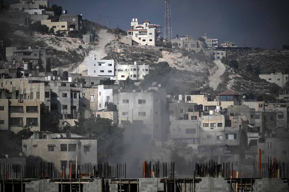 Smoke rises among buildings during an Israeli army raid in Jenin in the occupied West Bank on Friday. AFP