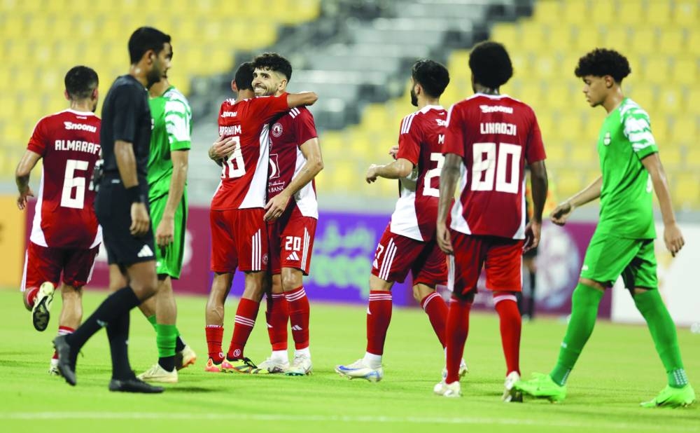 Al Arabi’s Luiz Martin (second left) celebrates with teammates after scoring against Al Ahli. 