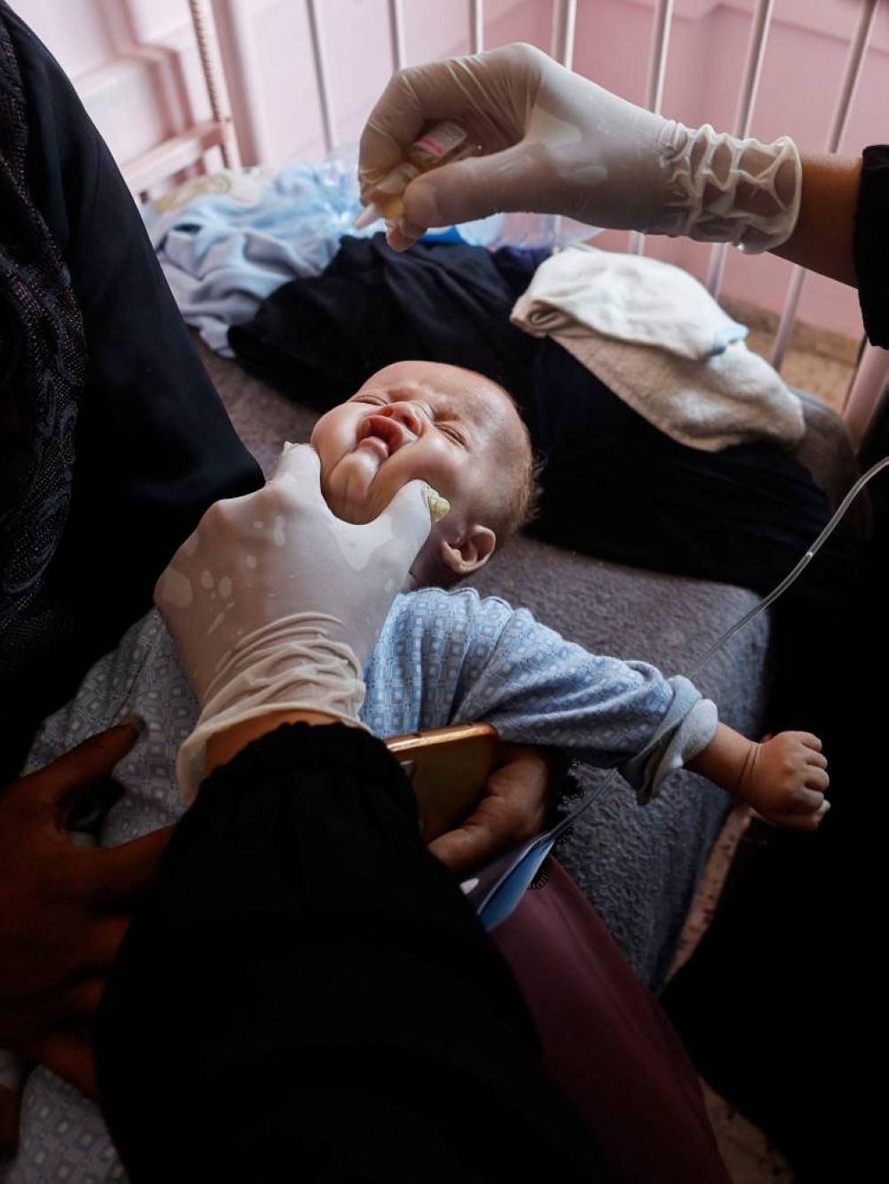 A Palestinian child is vaccinated against polio at Nasser hospital in Khan Younis in the southern Gaza Strip, Saturday. REUTERS