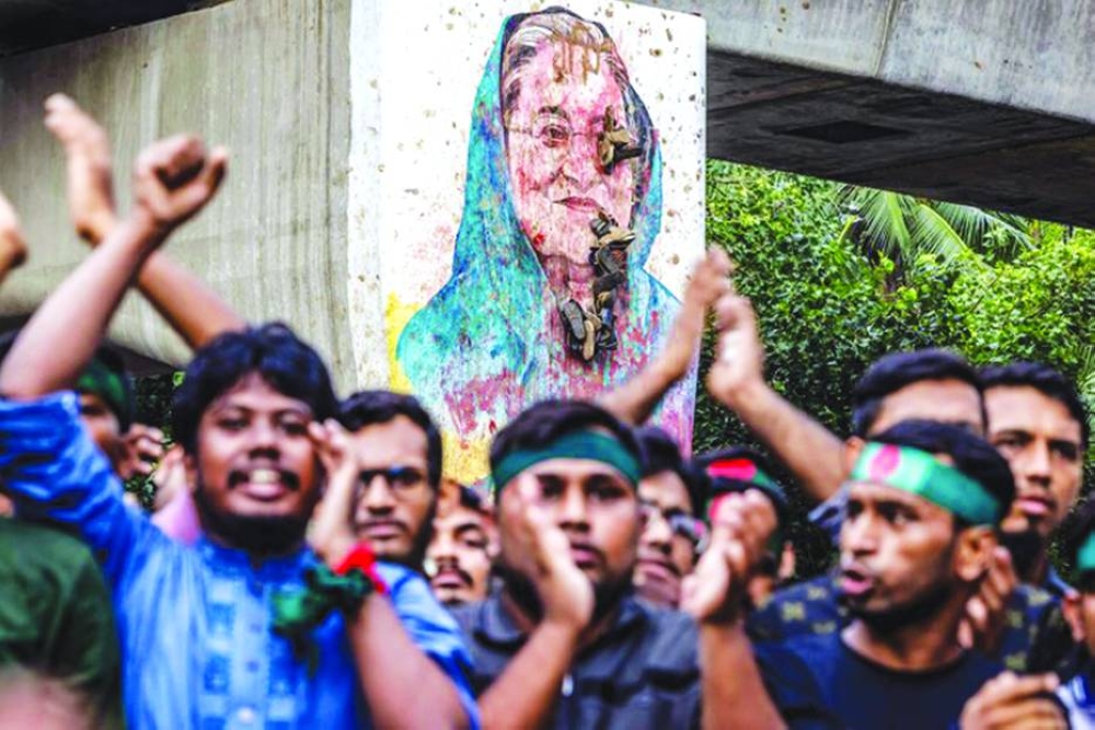 Students chant slogans near a vandalised mural of Bangladesh’s ousted prime minister Sheikh Hasina during a protest demanding accountability and trial against Hasina in Dhaka last month. (AFP)