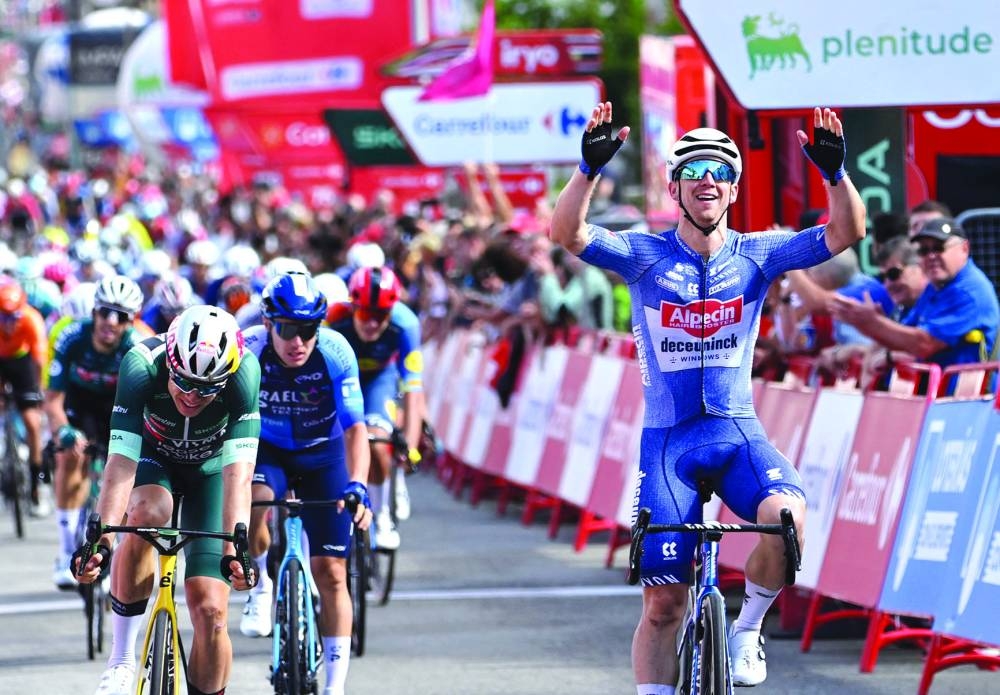 Team Alpecin’s Kaden Groves (right) celebrates after crossing the finish line of stage 14 of the Vuelta a Espana, a 200.5km race between Villafranca del Bierzo and Villablino, on Saturday. (AFP)
