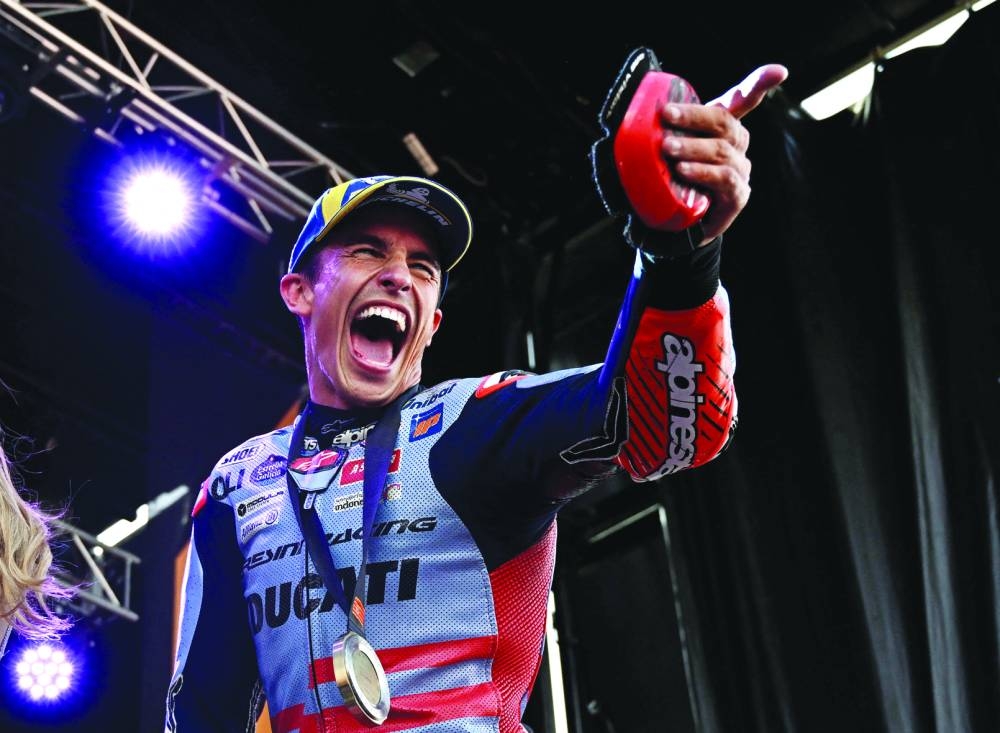Marc Marquez celebrates with his medal on the podium after winning the sprint at the Aragon Grand Prix, Alcaniz, Spain, on Saturday. (Reuters)