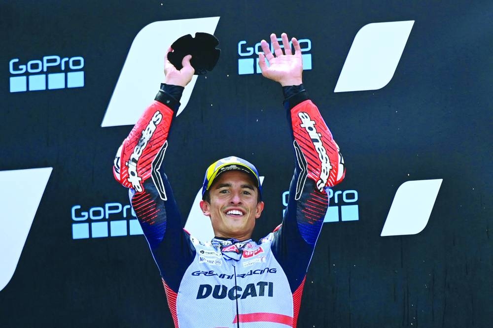 Spanish rider Marc Marquez celebrates on the podium after winning the MotoGP Aragon Grand Prix at the Motorland circuit in Alcaniz, northeastern Spain, on Sunday. (AFP)