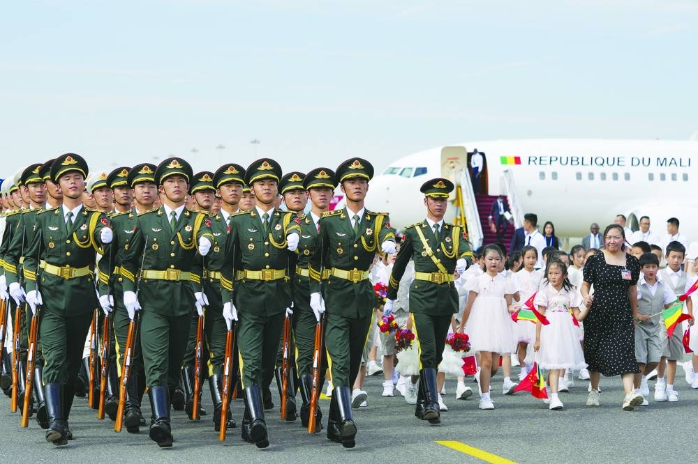 Members of the Chinese honour guard walk past as Interim President of Mali, Goita, arrives ahead of the 2024 Summit of the Forum on China-Africa Co-operation (FOCAC) in Beijing.