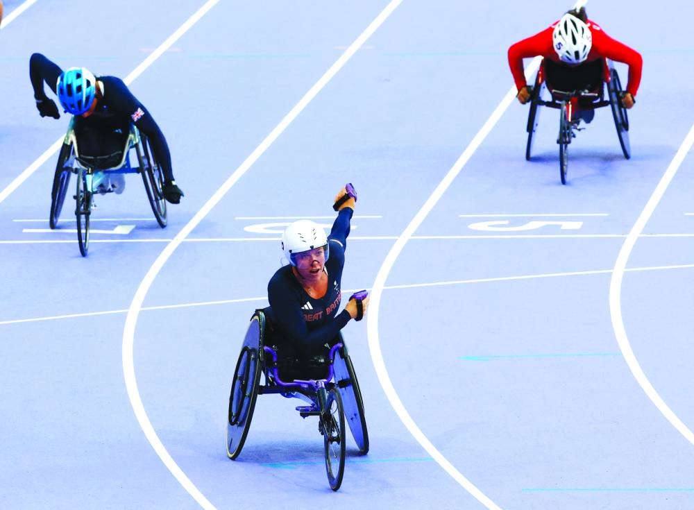 
Hannah Cockroft of Britain celebrates after winning gold in the women’s 100m T34 race. (Reuters) 
