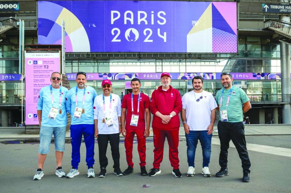 Ali Arshad poses with Qatar Olympic Committee first vice-president Mohamed bin Yousef al-Mana, head of the delegation Dr Hassan al-Ansari and other officials at the Stade de France in Paris on Sunday.