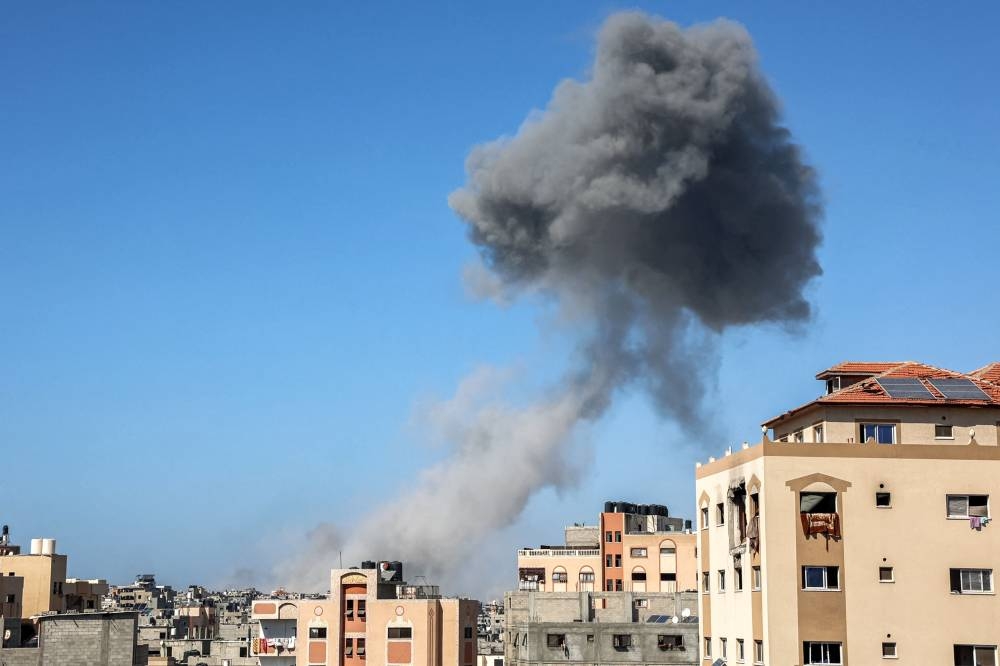 A smoke plume erupts from an explosion during Israeli bombardment in the Sheikh Radwan neighbourhood in the north of Gaza City on Tuesday. AFP