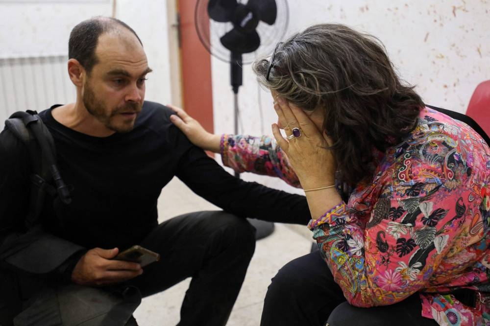 Colleagues of Aysenur Ezgi Eygi, US-Turkish activist who died after reportedly being shot in the West Bank town of Beita, react on news of her death in a hospital in Nablus in the occupied West Bank on Friday. AFP