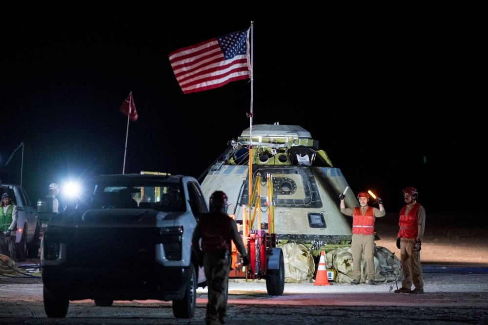 Boeing and NASA teams working around NASA's Boeing Crew Flight Test Starliner spacecraft after it landed uncrewed at White Sands, New Mexico on Friday.  AFP/NASA/Aubrey Gemignani