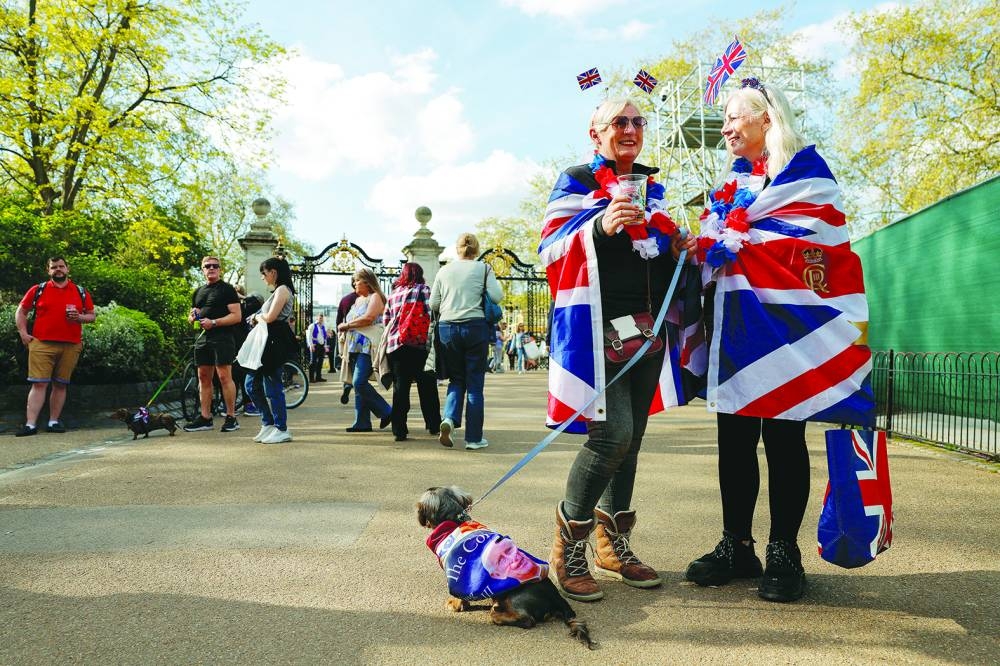 
People stand draped in Union Jack flags, as they celebrate Britain’s King Charles’ coronation, at St James’s Park, in London, in a file photo. 