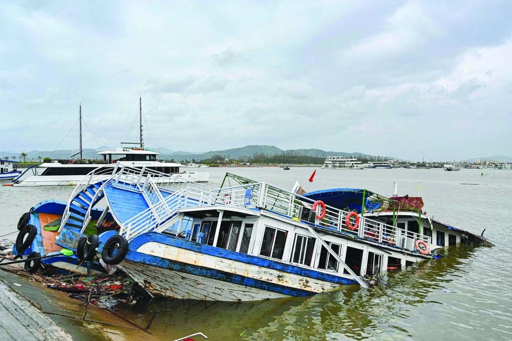 A boat damaged lies submerged in Ha Long bay, in Quang Ninh province.