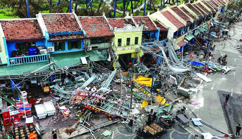 Damaged buildings and debris is seen on a street after Typhoon Yagi hit Ha Long, in Quang Ninh province, Vietnam, yesterday.