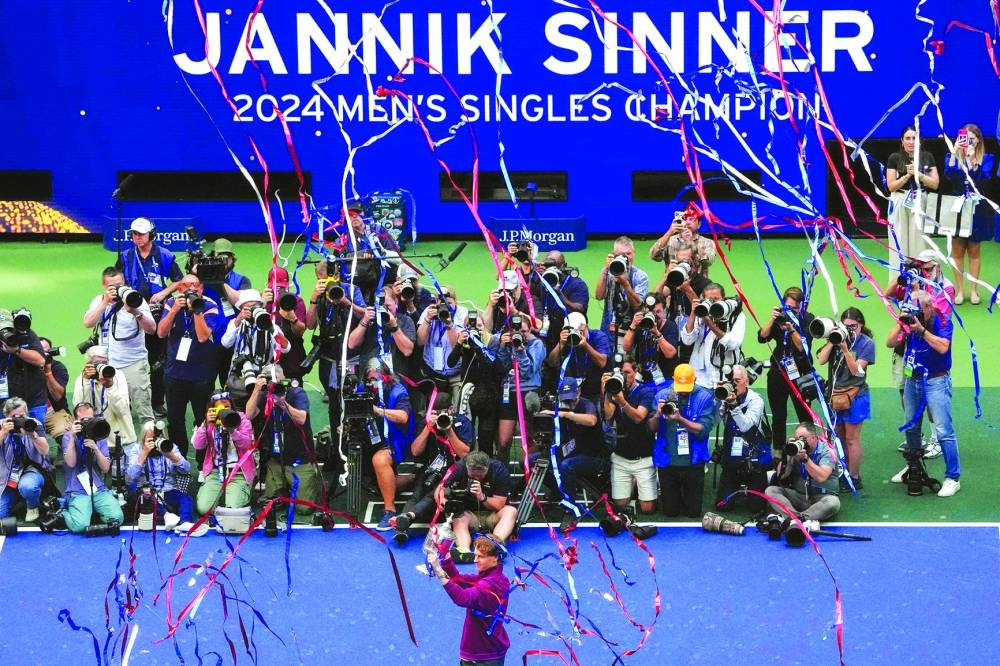 
Italy’s Jannik Sinner celebrates with the trophy after winning the final against USA’s Taylor Fritz on day fourteen of the US Open at the USTA Billie Jean King National Tennis Center in New York City, on Sunday. (AFP) 