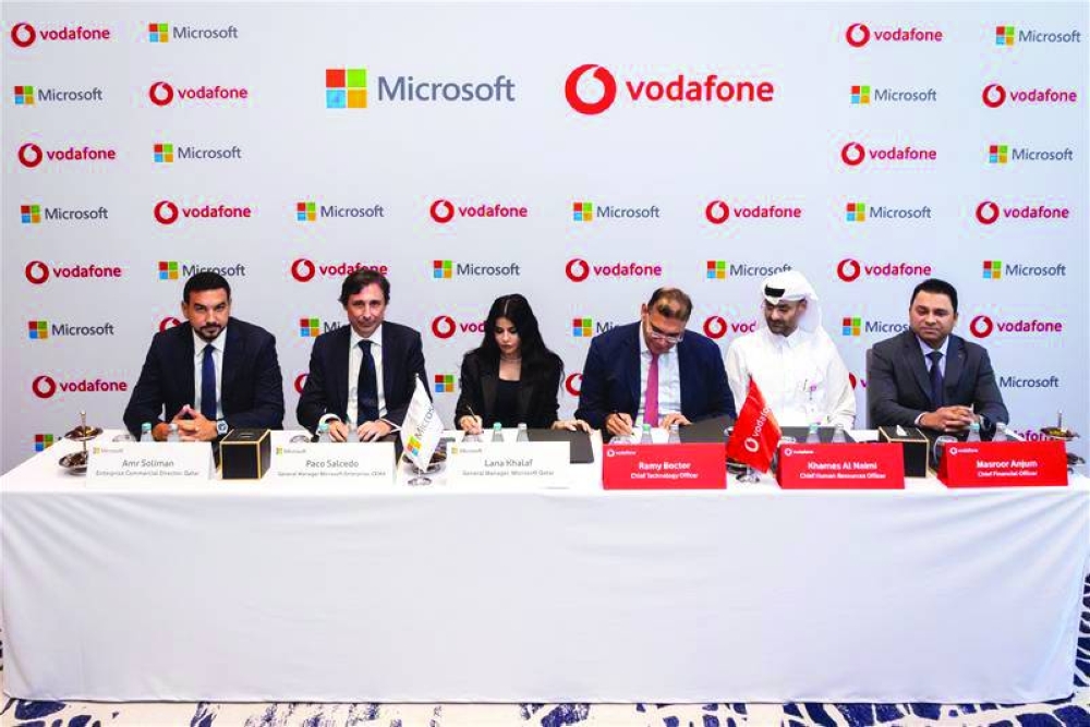 Ramy Boctor, Chief Technology officer at Vodafone Qatar, and Lana Khalaf, general manager of Microsoft Qatar, signing the agreement in the presence of key executives.
