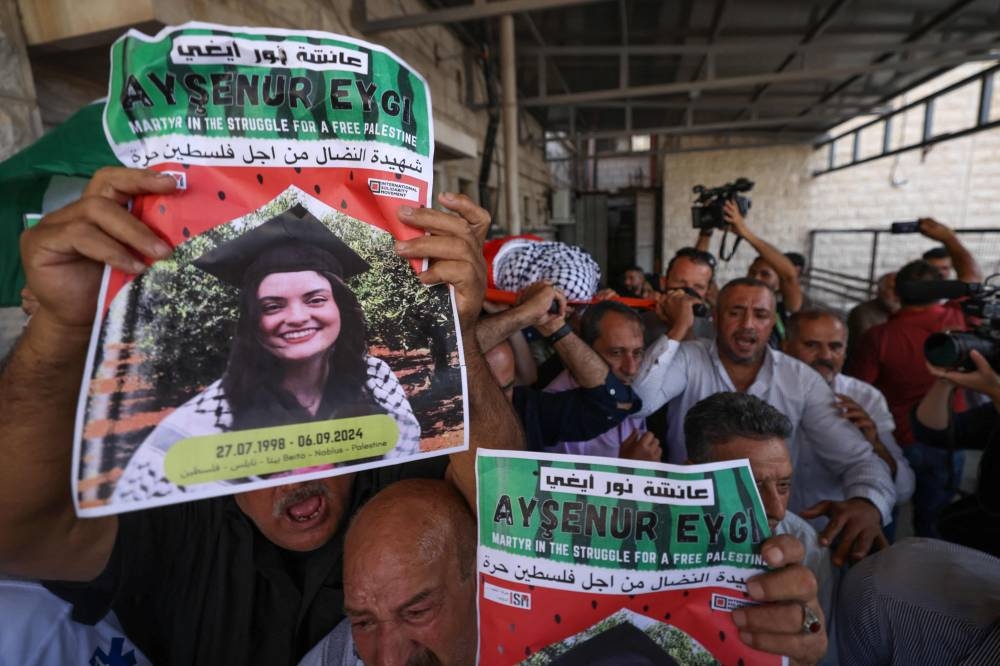 Palestinians carry the body of slain Turkish-American International Solidarity Movement activist Aysenur Ezgi Eygi during a funeral procession in Nablus Monday.
