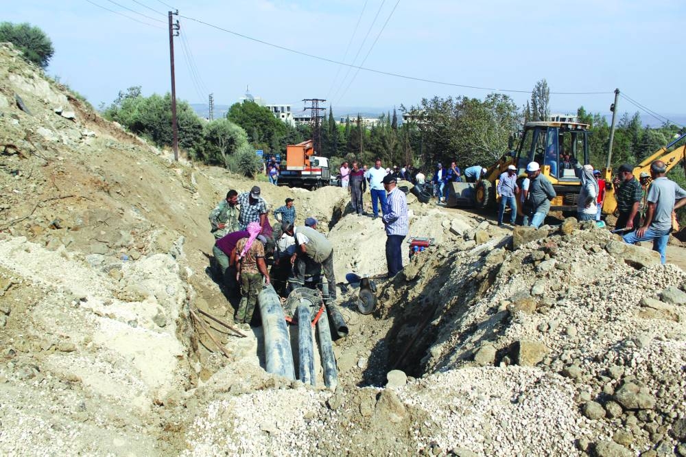 People inspect a damaged area in the aftermath of what Syrian state media reported was an Israeli strike in Masyaf, Hama province, Syria, yesterday.