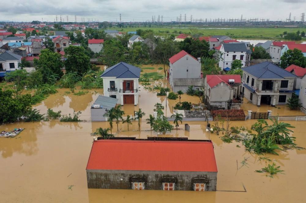 This aerial picture shows flood waters surrounding homes in Thai Nguyen province on Tuesday. AFP