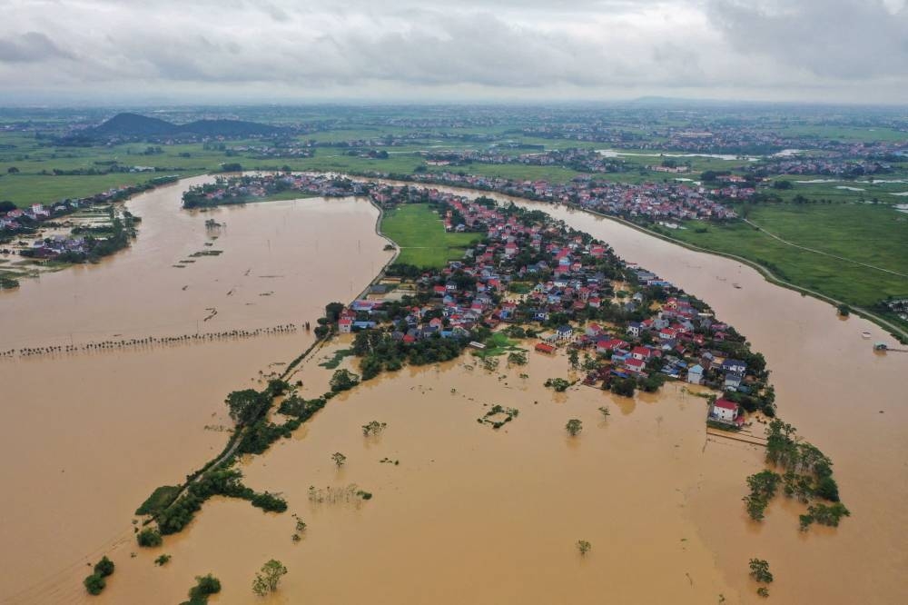 This aerial picture shows flood waters surrounding homes in Thai Nguyen province on Tuesday, in the aftermath of Typhoon Yagi hitting northern Vietnam. AFP