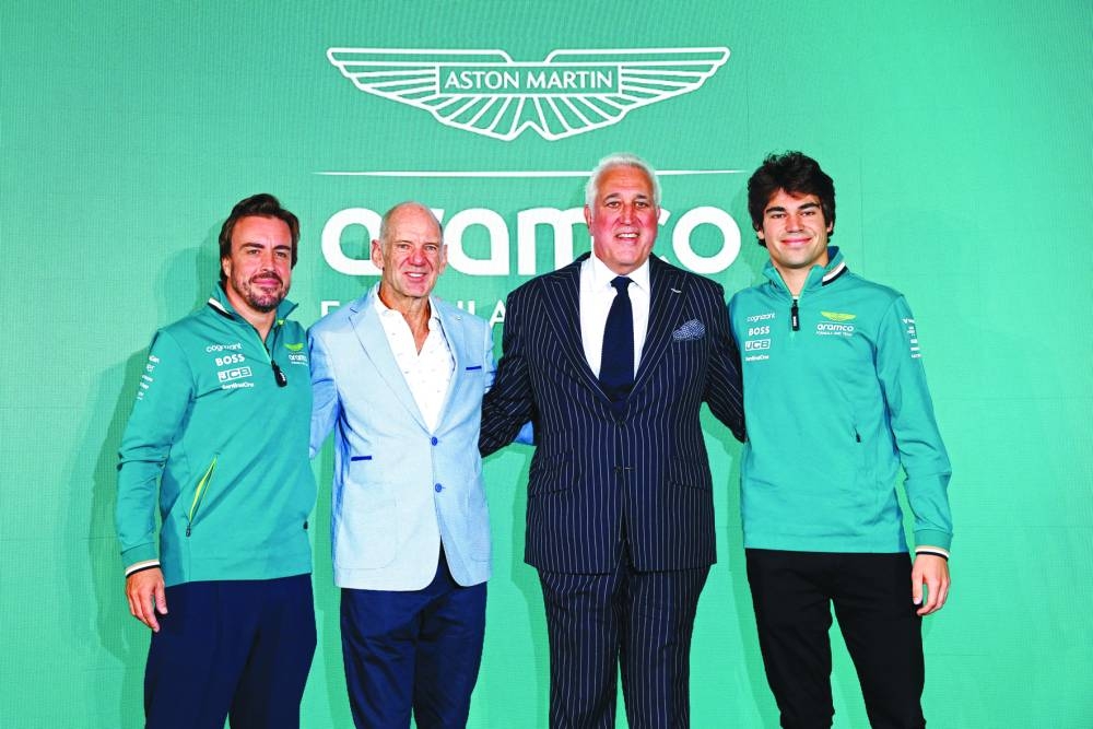 Aston Martin chairperson Lawrence Stroll with drivers Lance Stroll and Fernando Alonso, and new managing technical partner Adrian Newey after the press conference at AMR Technology Campus, Silverstone, Britain, on Tuesday. (Reuters)