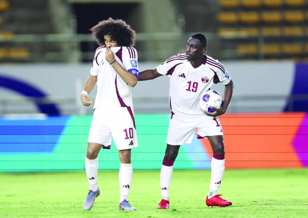 Qatar’s Akram Afif (left) celebrates with Almoez Ali after scoring a penalty against North Korea during the 2026 FIFA World Cup qualifying match at Laos Football Stadium in Vientiane, Laos, on Tuesday.
