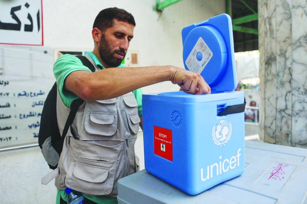 A Palestinian medic unpacks polio vaccines during an inoculation drive at the Al-Daraj neighbourhood clinic in Gaza City, on Tuesday.