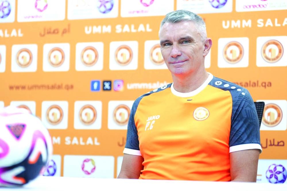 Umm Salal coach Carteron Patrice takes questions during a press conference.