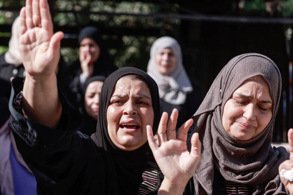 Palestinian relatives mourn during the funeral procession of men killed in an Israeli air strike in Tubas, amid an ongoing military raid in the northern occupied West Bank, on Friday. AFP