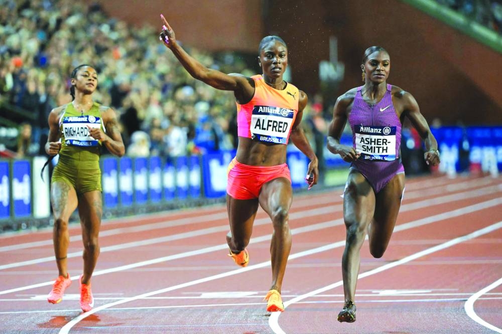 
St Lucia’s Julien Alfred (centre) gestures after crossing the finish line ahead of Britain’s Dina Asher-Smith (right) and Sha’Carri Richardson of the US in the women’s 100m event. 