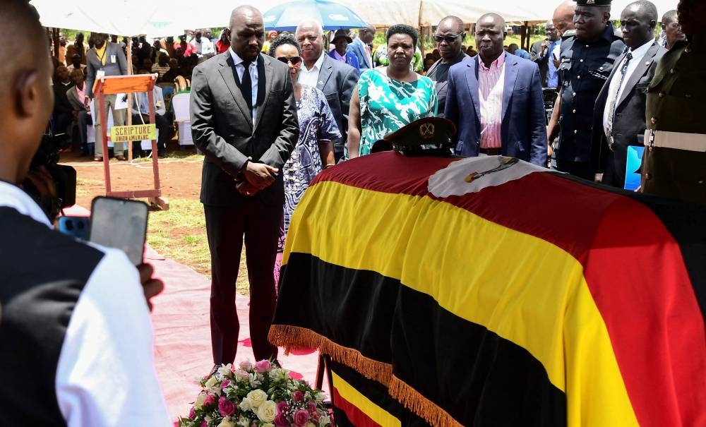 Kenya's Sports Cabinet Secretary Kipchumba Murkomen pays homage to the flag-draped coffin of the slain Ugandan Olympian Rebecca Cheptegei, before her burial at the Bukwo District, Uganda on Saturday. REUTERS