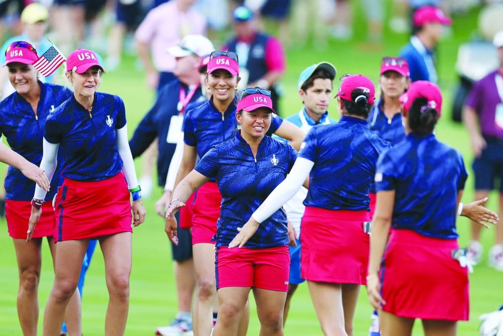 
Megan Khang and Nelly Korda of Team United States react with teammates Rose Zhang and Andrea Lee after winning their match during the Fourball matches against Team Europe during the first round of the Solheim Cup 2024. (AFP) 
