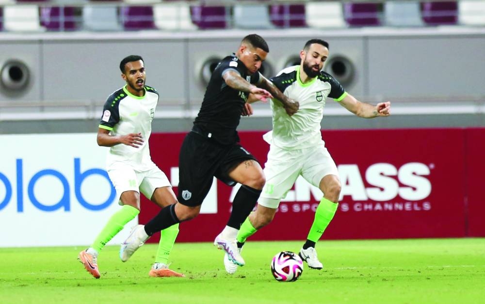 
Al Ahli and Qatar SC players vie for the ball at the Khalifa International Stadium. 