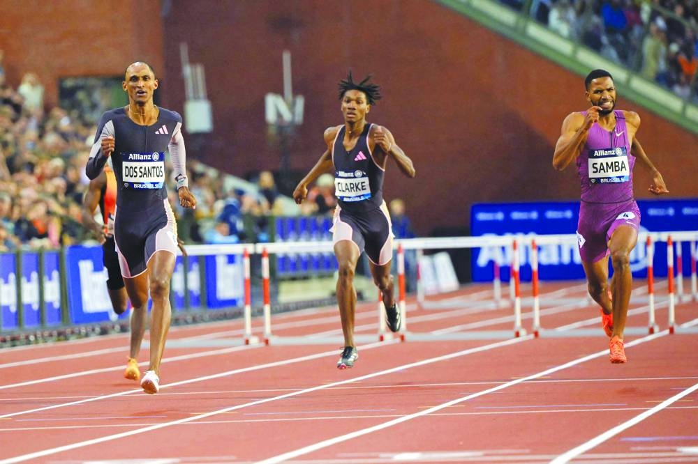 From left: Brazil’s Alison Dos Santos, Jamaica’s Roshawn Clarke and Qatar’s Abderrahman Samba compete in the 400m hurdles during the Diamond League finals at the Roi Baudouin Stadium in Brussels on Saturday. (AFP)