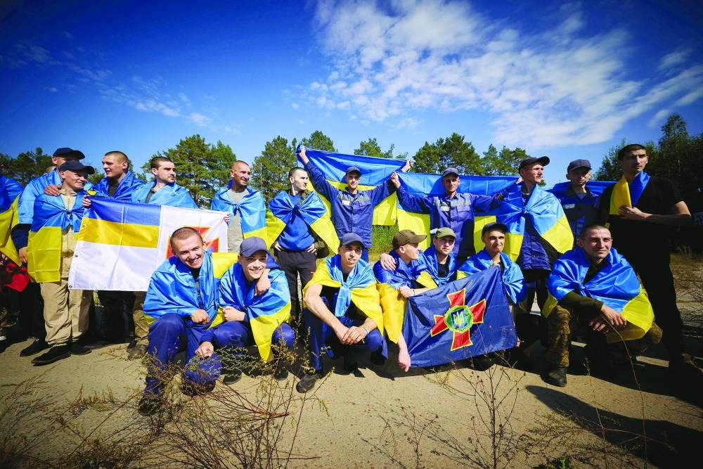 Ukrainian prisoners of war pose for a picture after a swap at an unknown location in Ukraine on Saturday. (Reuters)