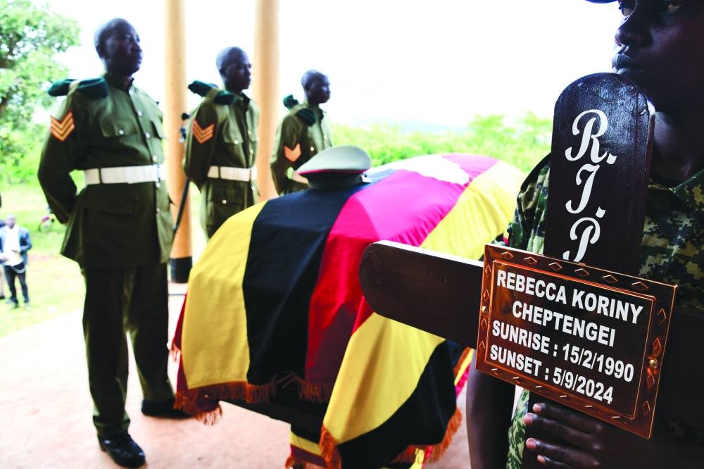 
Soldiers from Uganda People’s Defence Forces (UPDF) stand near the flag-draped coffin of the slain Ugandan Olympian Rebecca Cheptegei, who died after her former boyfriend doused her in petrol and set her ablaze. The coffin was received at the local council for a special sitting before her burial at the Bukwo District, Uganda. – Reuters 