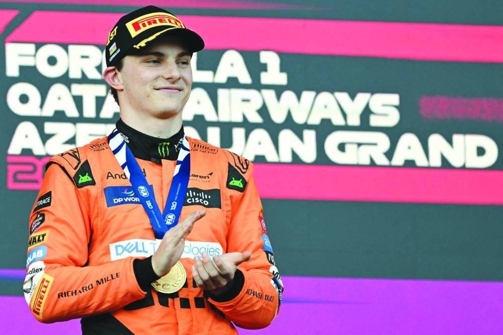 McLaren's Australian driver Oscar Piastri celebrates on the podium after winning the Formula One Azerbaijan Grand Prix at the Baku City Circuit in Baku on Sunday. (AFP)