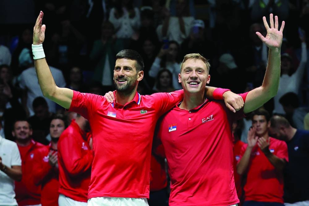 Serbia’s Novak Djokovic (left) and Hamad Medjedovic celebrate after winning against Greece’s Petros Tsitsipas and Aristotelis Thanos during the group stage Davis Cup doubles match at the Aleksandar Nikolic Hall in Belgrade on Sunday. (AFP)