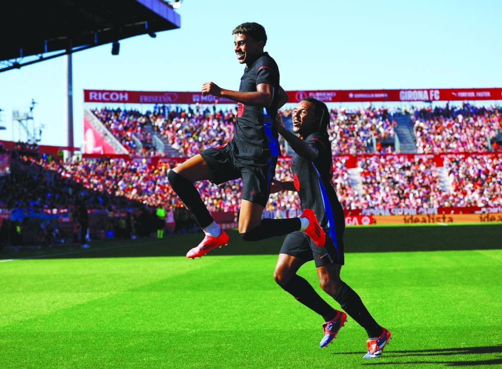 
Barcelona’s Lamine Yamal (left) celebrates with Jules Kounde after scoring against Girona. (Reuters) 