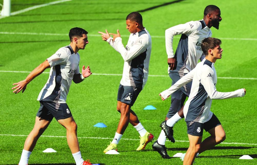 Real Madrid’s French forward Kylian Mbappe (centre) attends a training session on the eve of their UEFA Champions League match against Stuttgart VFB at the club’s training facilities of Valdebebas, in the outskirts of Madrid, on Monday. (AFP)