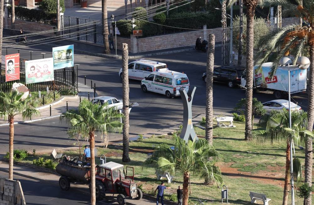 Ambulances drive, as more than 1,000 people, including Hezbollah fighters and medics, were wounded on Tuesday when the pagers they use to communicate exploded across Lebanon, according to a security source, in Sidon, Lebanon on Tuesday. REUTERS