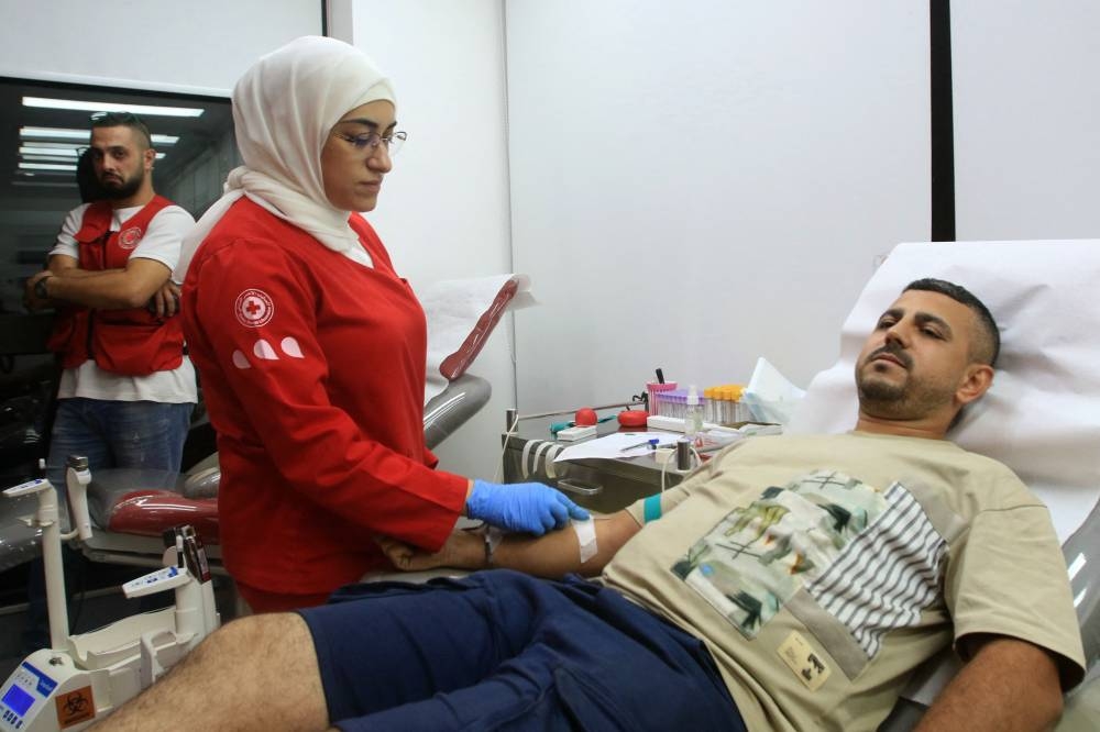 A man donates blood in the southern Lebanese city of Saida on Tuesday, after explosions hit locations in several Hezbollah strongholds around Lebanon. AFP