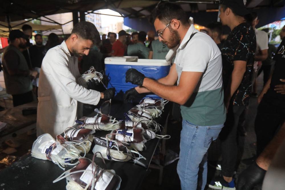 Medics collect blood donations in Beirut's southern suburb on Tuesday, after explosions hit locations in several Hezbollah strongholds around Lebanon. AFP