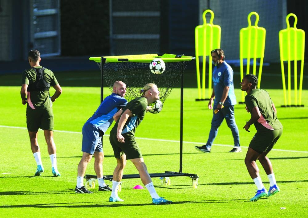 Manchester City’s Manuel Akanji (right) and Erling Haaland train on Tuesday. (Reuters)