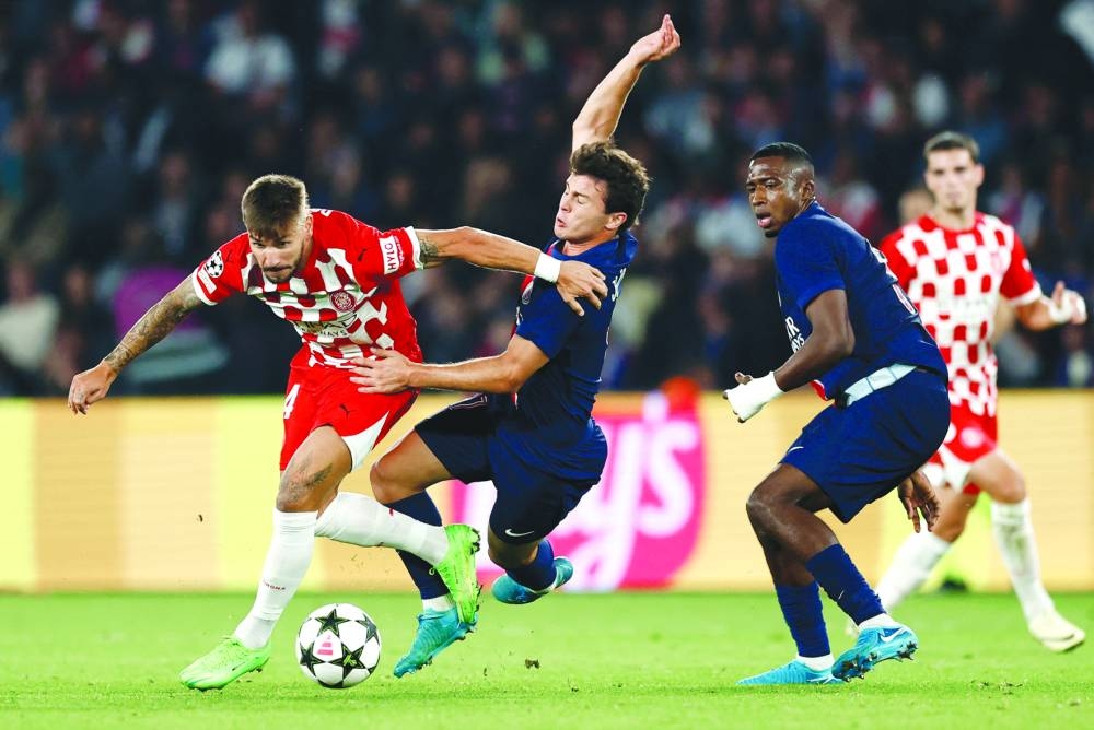 
Girona’s Portu (left) and Paris St Germain’s Joao Neves vie for the ball during the Champions League match in Paris. (Reuters) 