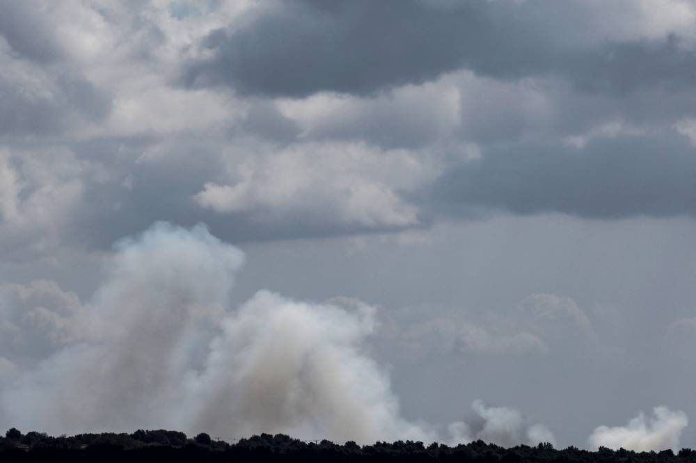 Smoke billows over hills in the Israeli-annexed Golan Heights after rockets were fired from southern Lebanon on Friday. AFP