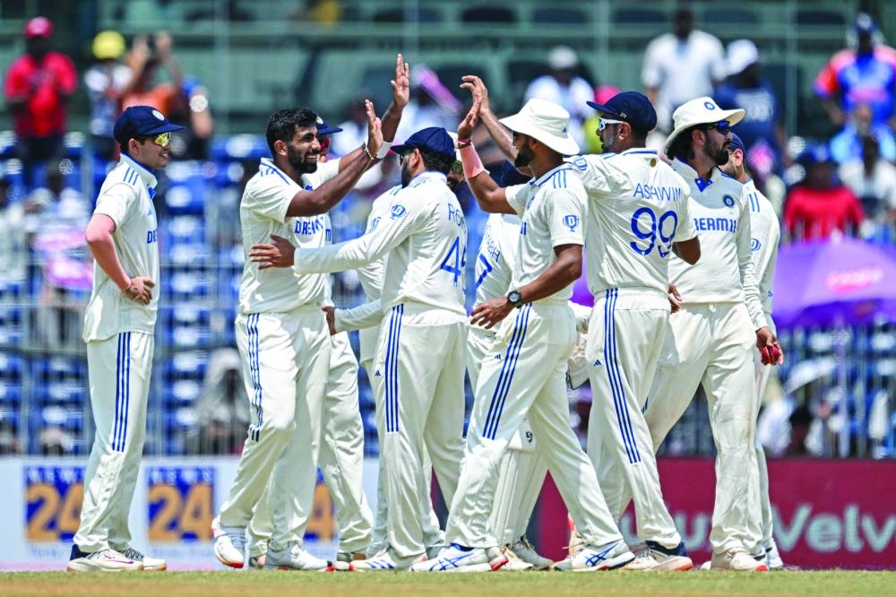 India’s Jasprit Bumrah celebrates with teammates after taking the wicket of Bangladesh’s Mushfiqur Rahim during the second day of the first Test against Bangladesh at the MA Chidambaram Stadium in Chennai on Friday. (AFP)