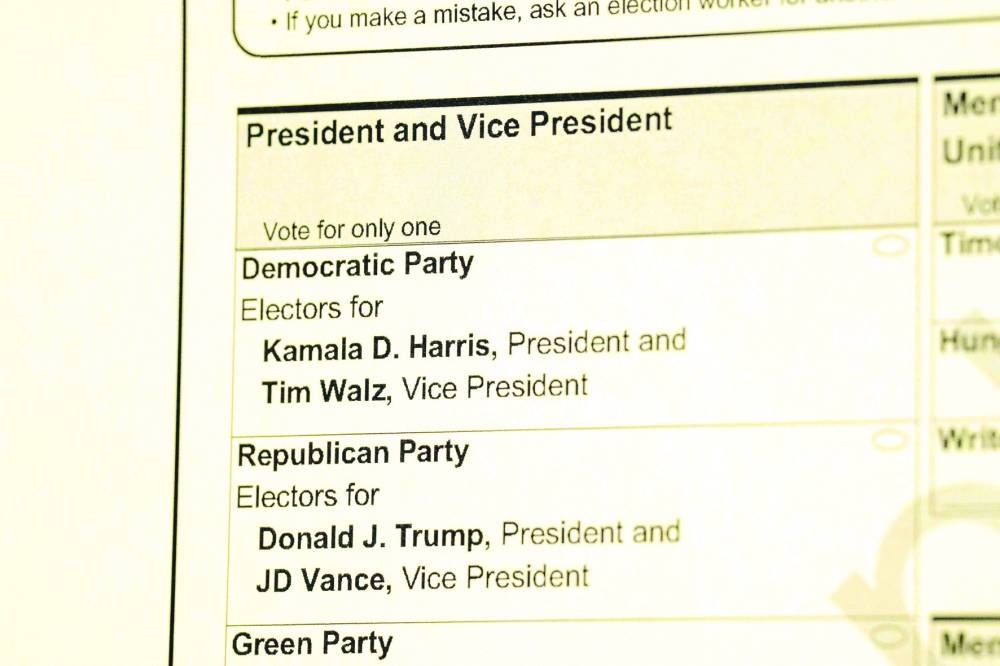 Right: A sample ballot is displayed on the first day of Virginia’s in-person early voting. – AFP