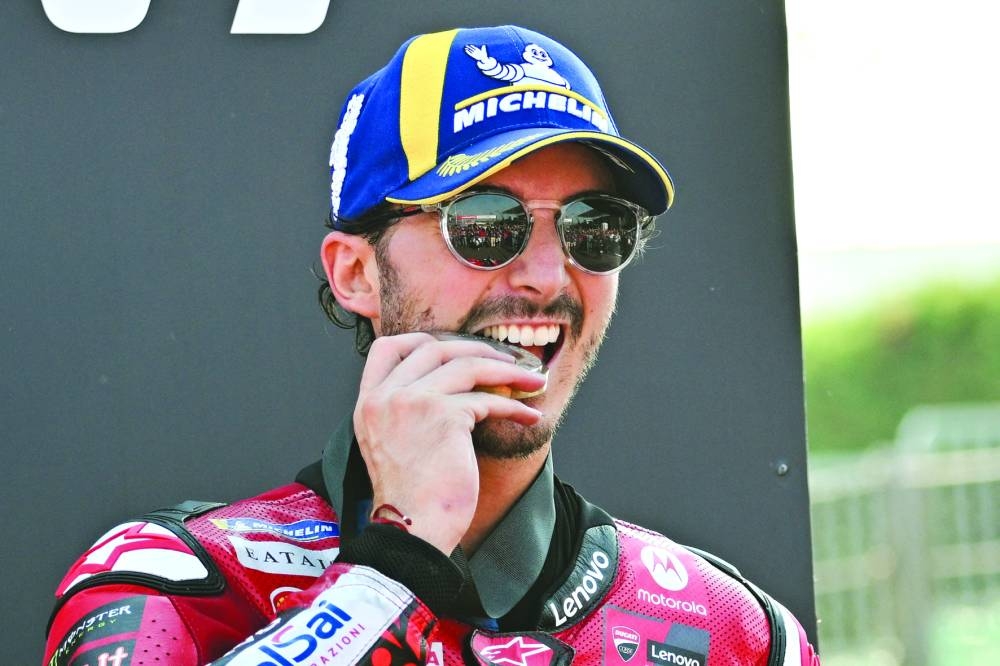 First place Ducati Italian rider Francesco Bagnaia celebrates on the podium after the sprint race of the Emilia-Romagna MotoGP Grand Prix at the Misano World Circuit Marco-Simoncelli in Misano Adriatico, on September 21, 2024. (Photo by Andreas SOLARO / AFP)