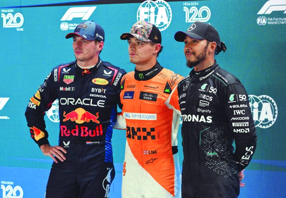 McLaren’s Lando Norris celebrates after qualifying in pole position with second-placed Red Bull’s Max Verstappen and third-placed Mercedes’ Lewis Hamilton. (Reuters)